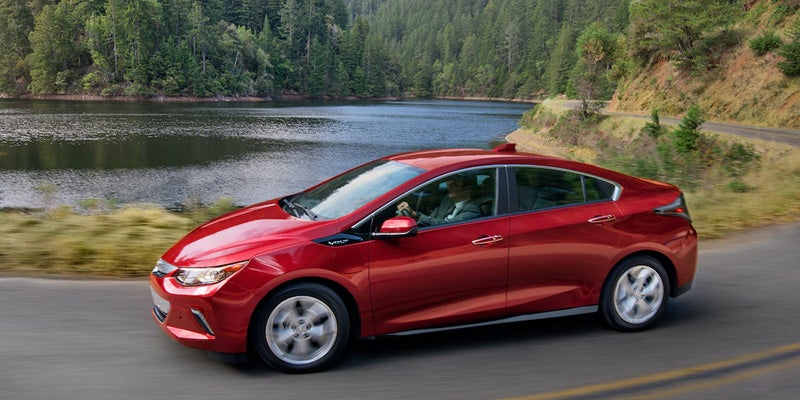 Chevrolet Volt gliding past a tranquil lakeside view.