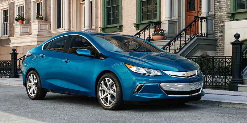 Chevrolet Volt, right side view near an apartment, showcasing its classy exterior.